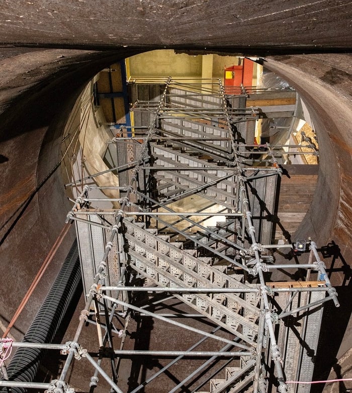 Metal scaffolding stairs inside a circular draft tube at the Rock Island Hydroelectric Project.